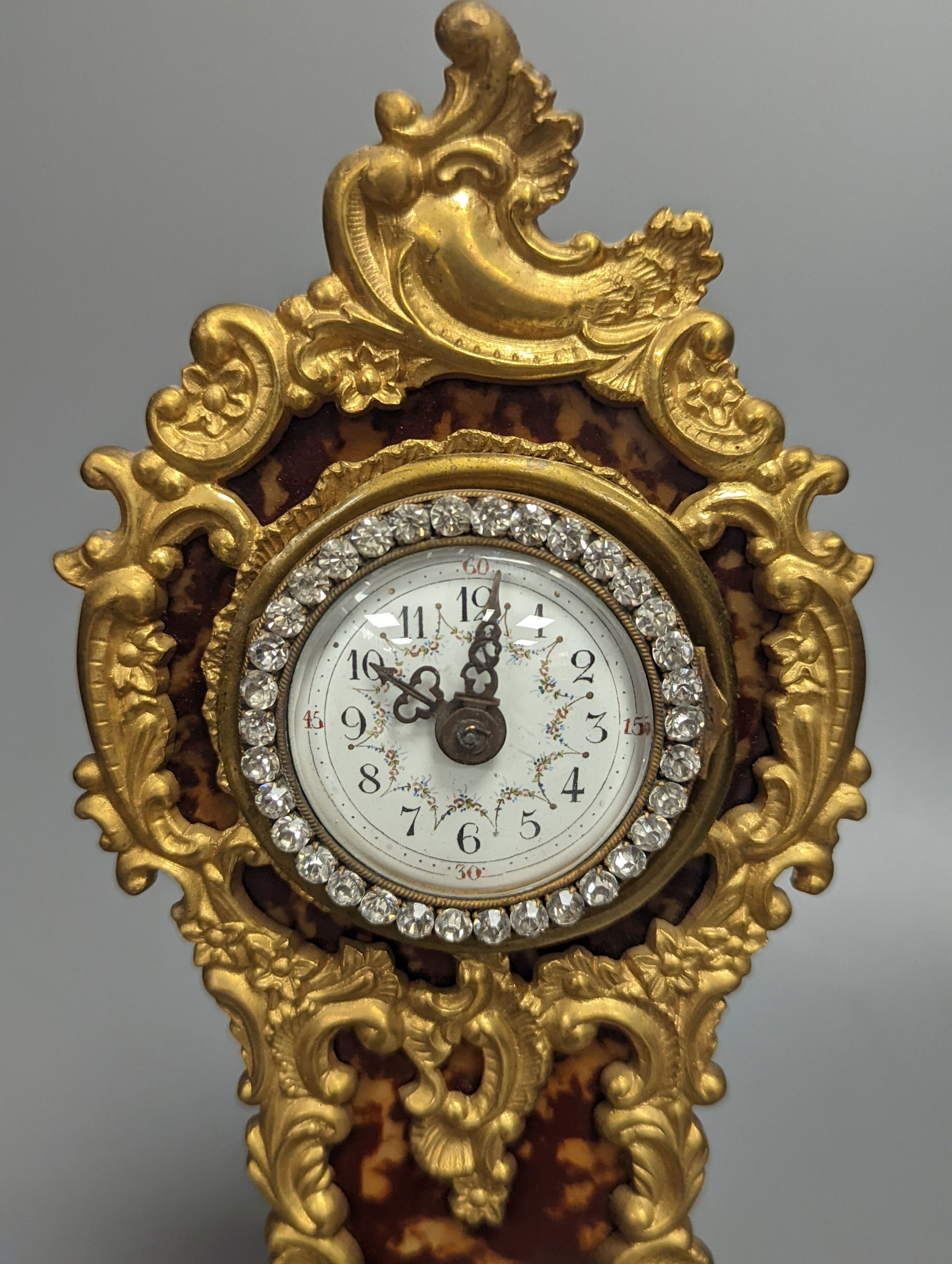 A French timepiece, with paste-set face, in simulated tortoiseshell case, height 25cm